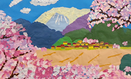 明石芸術祭音楽出演時に使用した貼り絵。小さな村と背後に大きな山、手前には満開の桜が描かれている。